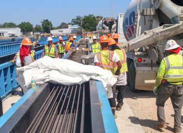 construction workers building bridge at Pensacola Bay